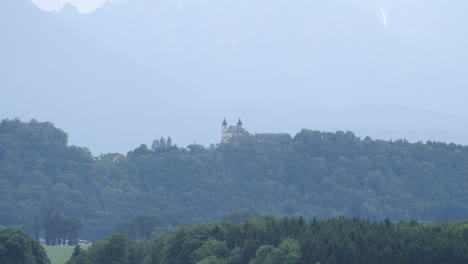 beautiful austrian building on horizon in alps mountain foothills