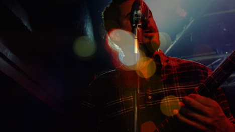 animation on blurred night road traffic over biracial male singer with guitar on concert