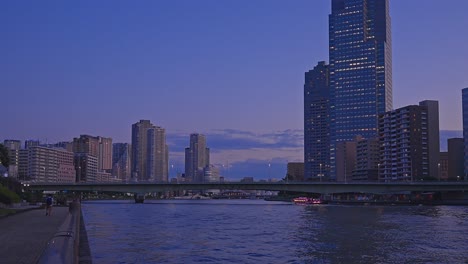 Evening-Tokyo,-Tsukuda,-Toyosu-skyscrapers-and-bridge-the-Sumida-River