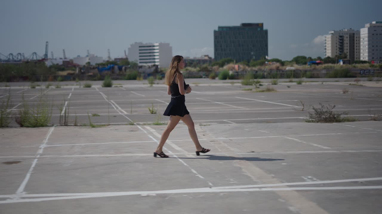 Woman Walking in Urban Parking Lot