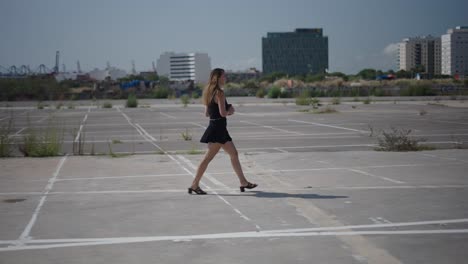 woman walking in urban parking lot