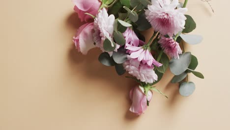 Video-of-bunch-of-white-and-pink-flowers-and-copy-space-on-yellow-background