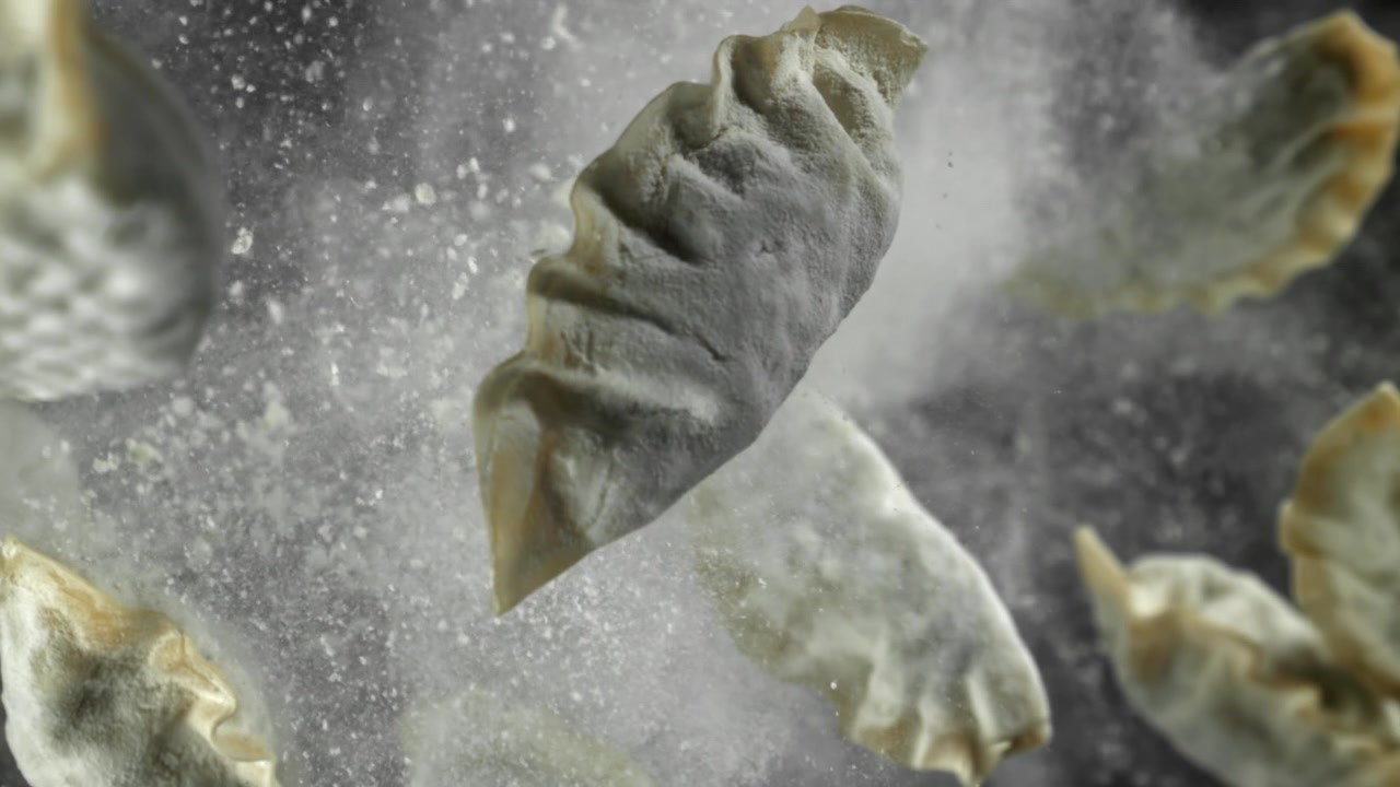Frozen Dumplings Falling with Flour in Slow Motion
