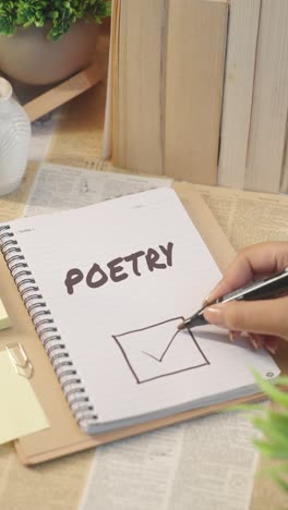 vertical video of ticking off poetry work from checklist