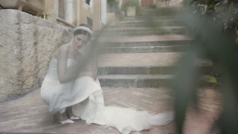 bride sitting on stone steps