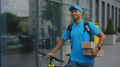 delivery person with bicycle in front of building