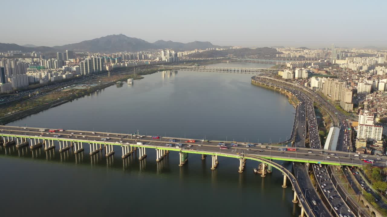 Bridge and traffic at sunrise in Seoul Korea over the Han River.