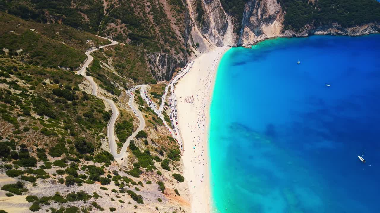 Drone Aerial and Cinematic View of the Myrtos Beach in Kefalonia. One of the most spectacular beaches in Greece and the Mediterranean. Surrounded by steep cliffs and lush green hills. DJI MINI 4PRO