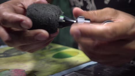 close-up shot of a tattoo artist getting his tools ready for the next session