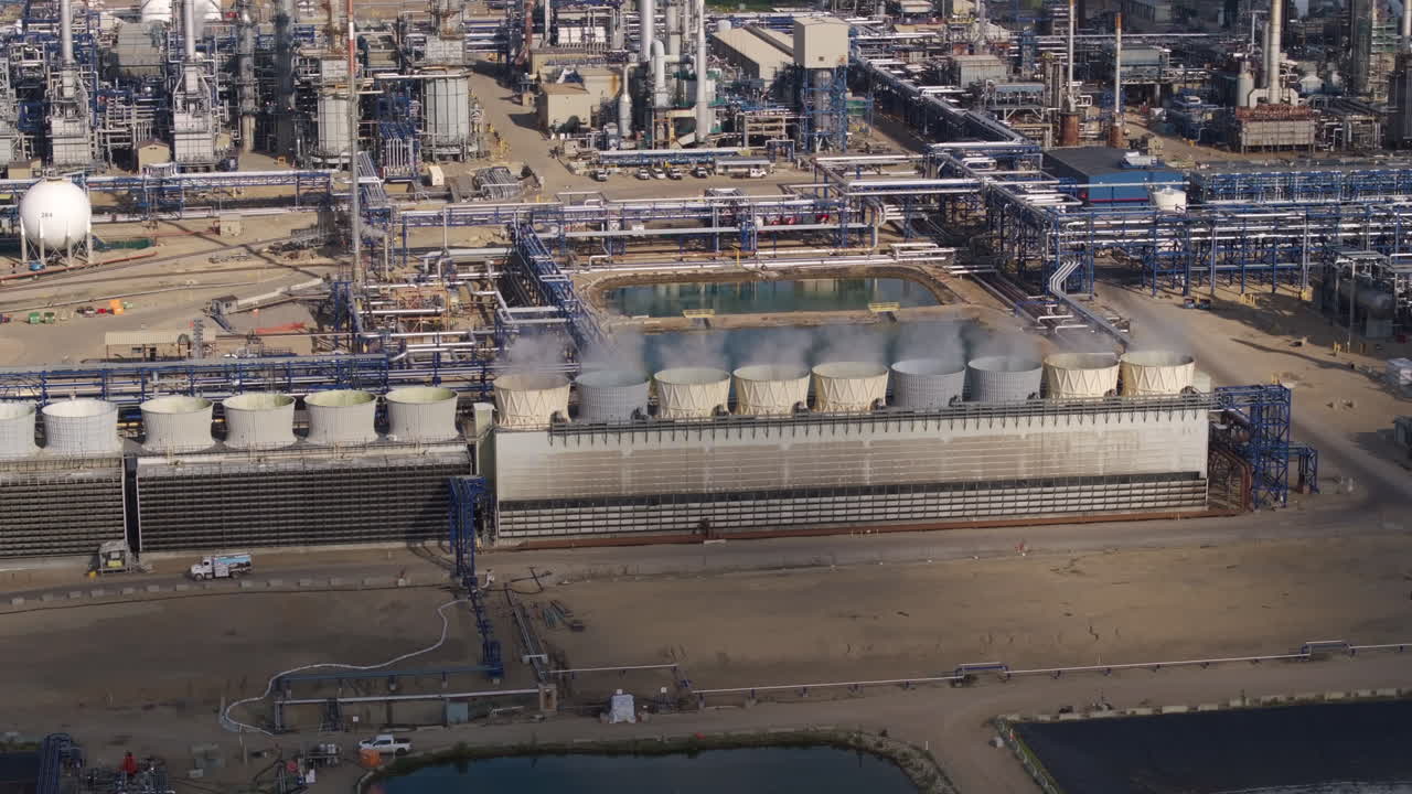 Aerial view of expansive industrial factory complex under sunny sky