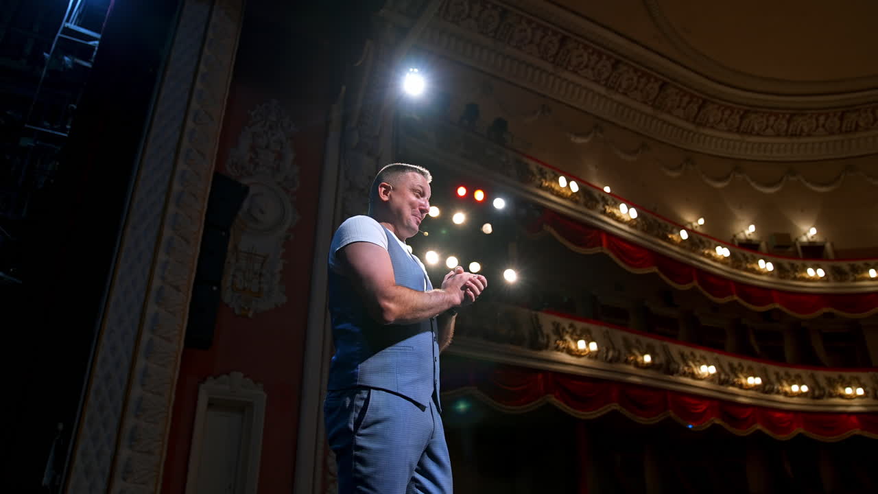 Leading man on stage of theatre. Medium shot of actor performing monologue in theater