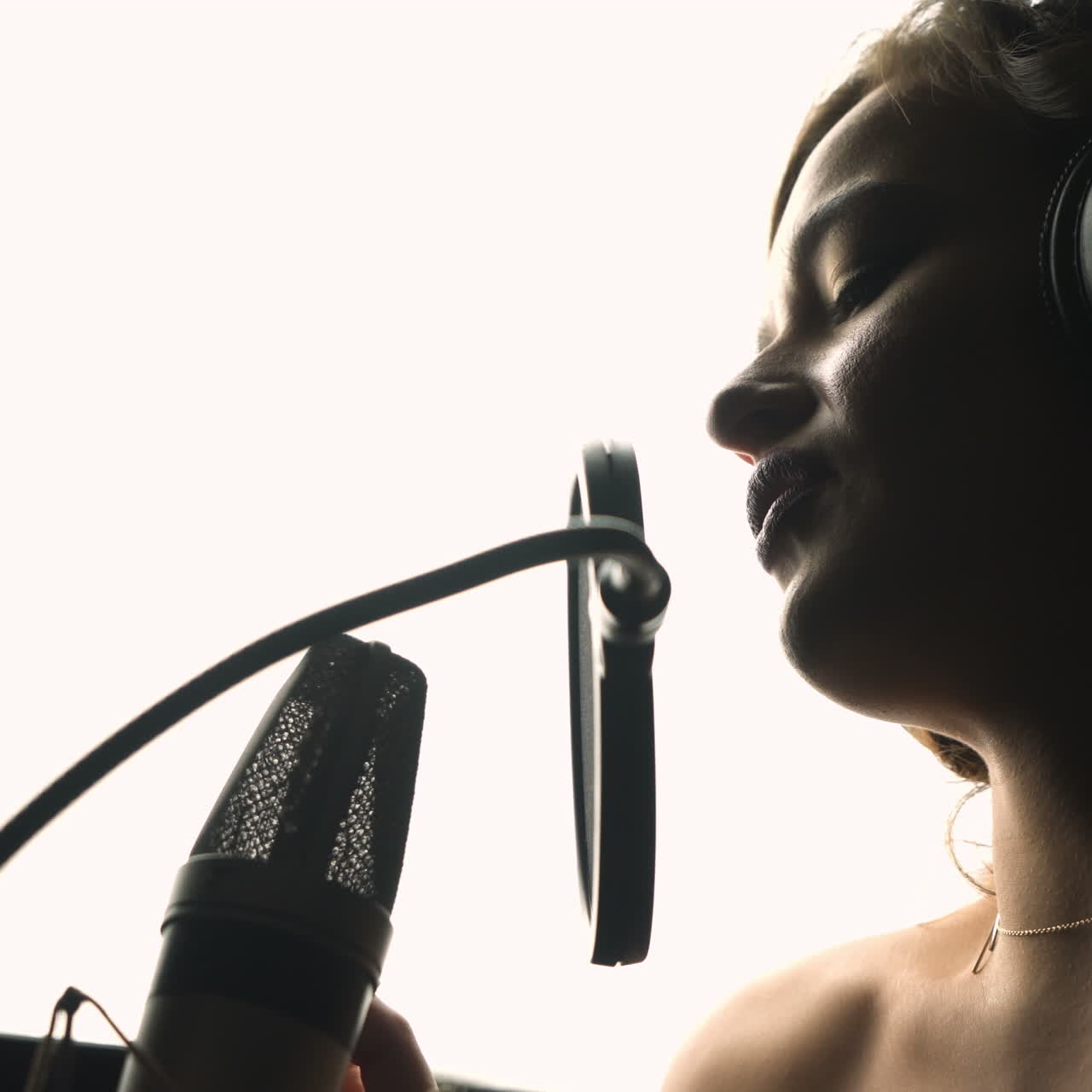 Beautiful sexy young woman singing. Female vocal. Professional recording studio. Close-up face. Square video