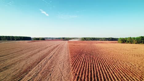 Harvester-machine-working-in-soybean-field,-aerial-view,-Georgia