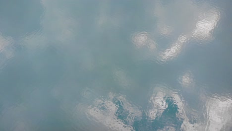 aerial overhead view of turquoise waters of lake limmernsee and hydroelectric dam in linthal glarus, switzerland