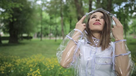 girl smiles and laughs in the rain the rain falls the drops fall on his face and the girl is hap girl smiles and laughs in the rain the rain falls the drops fall on his face and the girl is happy with life and nature around concept of nature and happy life adventure purity