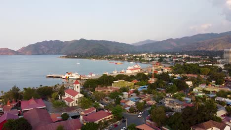 scenic aerial view of urban capital city of dili, timor-leste in southeast asia with hills, streets, traffic, buildings, churches and ocean