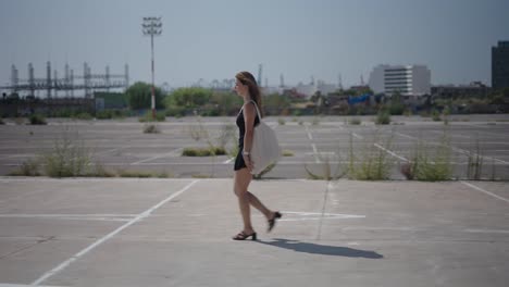 woman walking in an empty parking lot