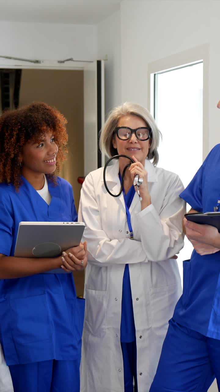 Diverse Group of Medical Professionals Discussing in Hospital Hallway