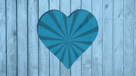 animation of rotating blue striped background over heart shapes hole in blue wooden surface