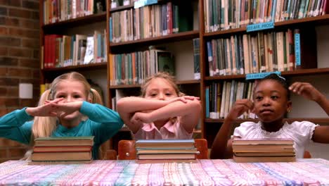 cute little girls posing with library books