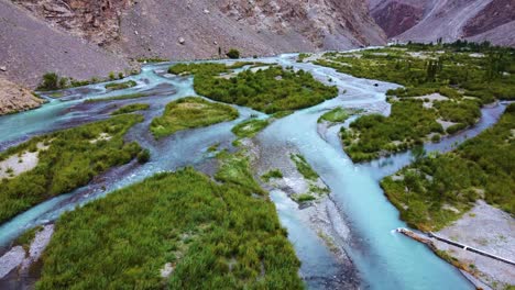 aerial shot revealing beauty of souq valley with breathtaking view of turquoise water in skardu, pakistan