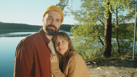 portrait of romantic tourist couple on lakeshore