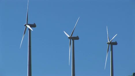 mediumshot of three wind turbines generating power at tehachapi california