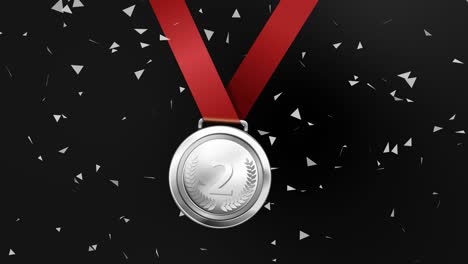 silver medal with red ribbon and confetti