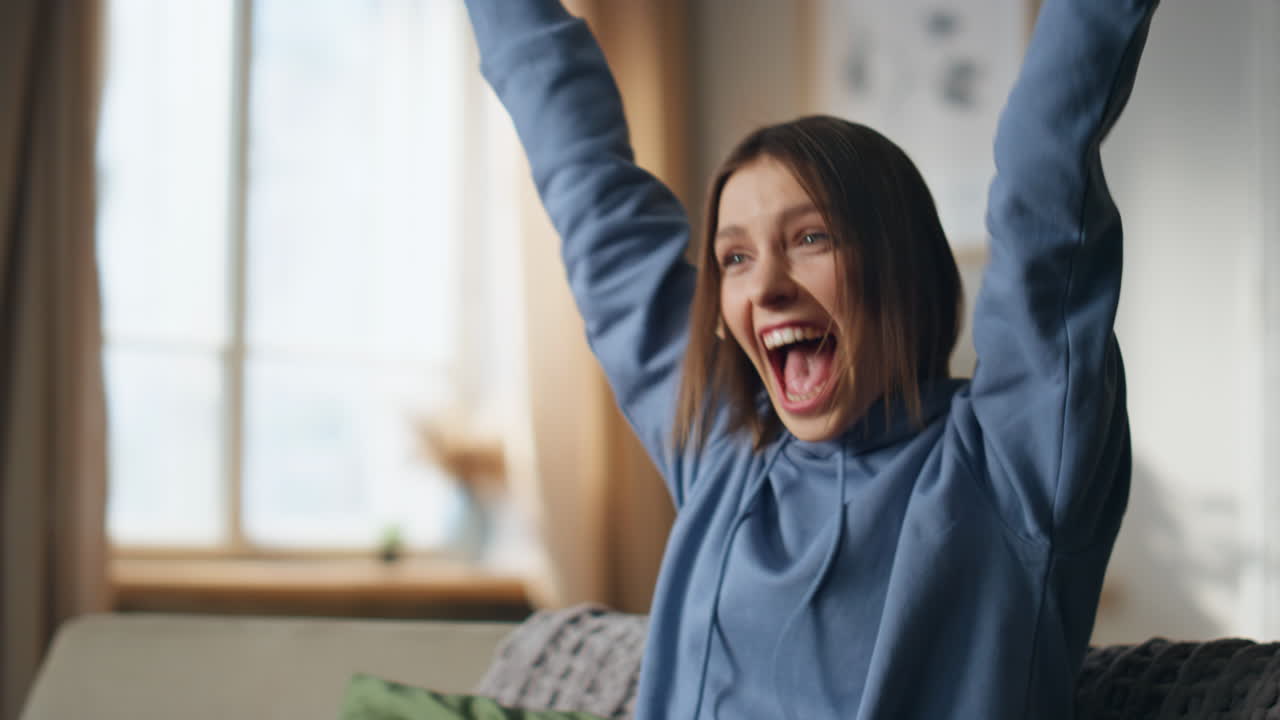 A woman watching television with excitement
