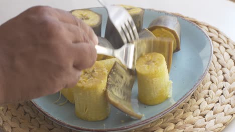 peeling steaming hot boiled plantain bananas, part 4