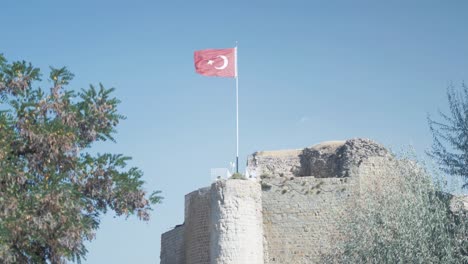 turkish flag flys atop harput historic castle