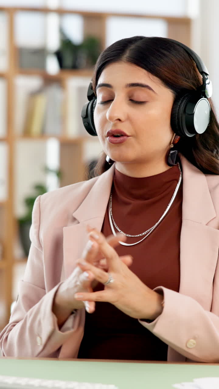 Young Professional Woman Talking and Gesturing with Headphones