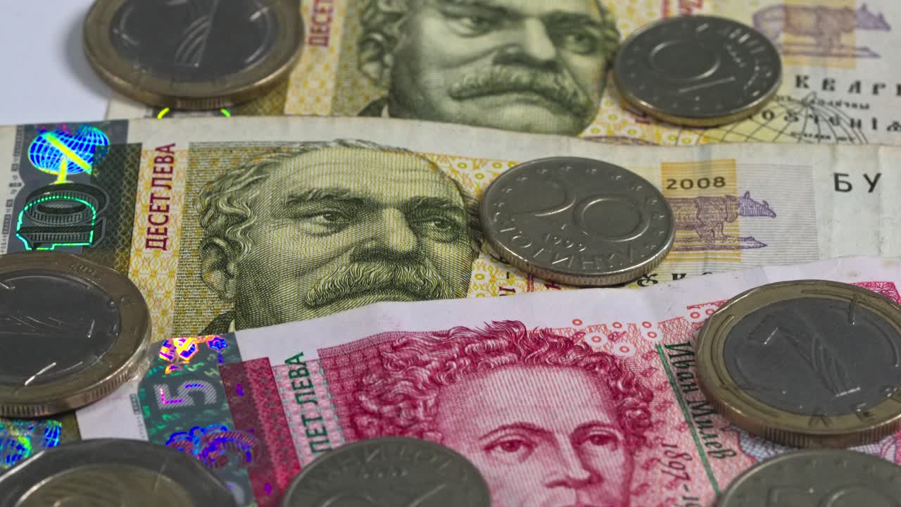 Various coins and banknotes arranged on a flat surface in a close view