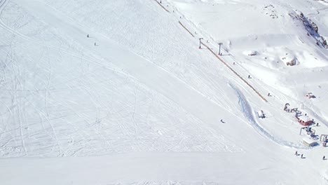 Slow-motion-shot-of-people-skiing-on-the-slopes-of-El-Colorado-within-the-Farellones,-Chile