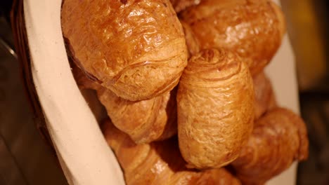 close-up of golden croissants in a basket
