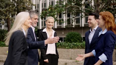 Business people shaking hands outdoors