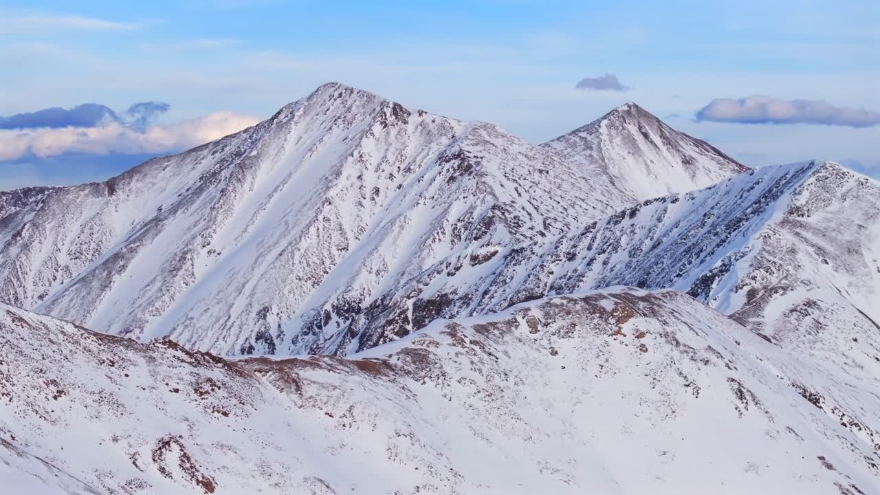 Dead Dog couloir Grays and Torreys 14er Peak Loveland Pass winter spring golden hour sunset Colorado aerial drone forward pan up panorama landscape high clouds backcountry snow Rocky Mountains