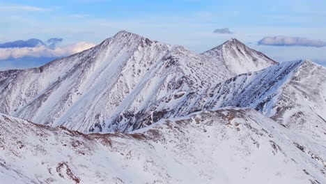 Dead Dog couloir Grays and Torreys 14er Peak Loveland Pass winter spring golden hour sunset Colorado aerial drone forward pan up panorama landscape high clouds backcountry snow Rocky Mountains