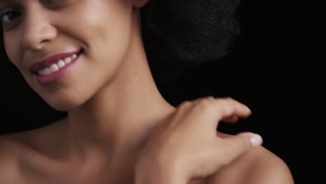 close up portrait attractive african american woman touching face with hands caressing smooth healthy skin complexion enjoying perfect natural beauty funky afro on black background