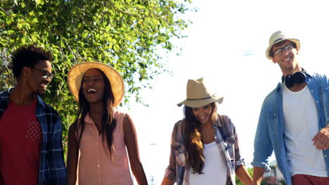 hipsters are holding by hand and walking in the street