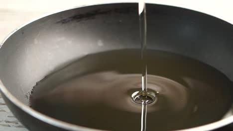 pouring oil into a pan