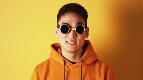 man in orange hoodie and welding glasses