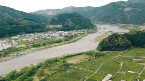 Exuberantes-Granjas-De-Té-Con-El-Río-Oi-Cerca-Del-Pueblo-De-Montaña-En-Kawane-En-La-Prefectura-De-Shizuoka,-Japón