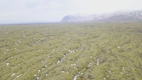 aerial shot panning over beautiful green icelandic terrain
