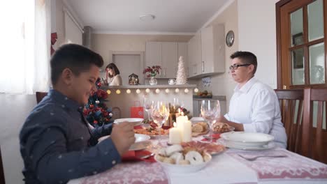 family sitting at the christmas table for a meal