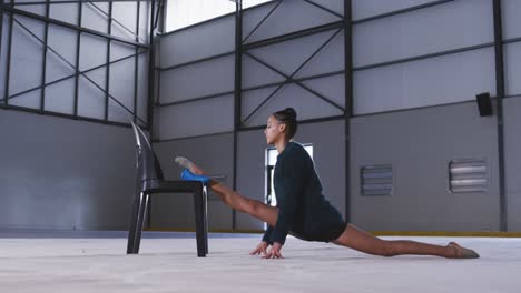 Female-gymnast-performing-at-sports-hall