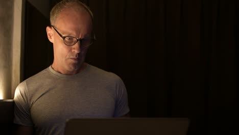 mature scandinavian man using laptop with eyeglasses