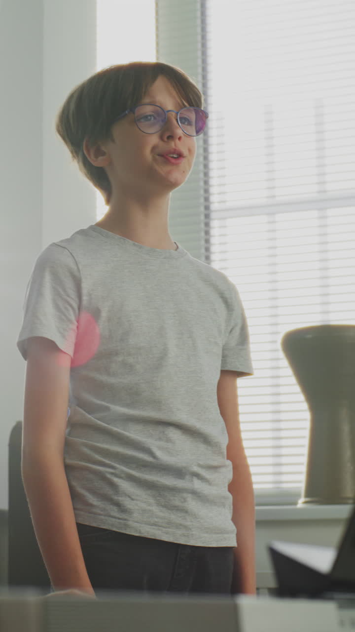 Primary School Boy Practicing Vocals During Singing Lesson Music Teacher Playing Piano