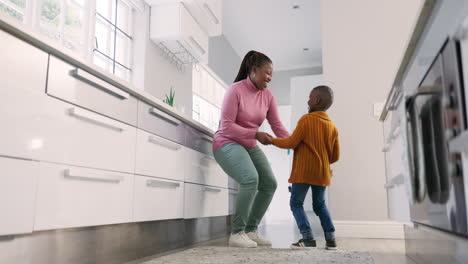 Mother,-kitchen-and-black-family-child-dancing