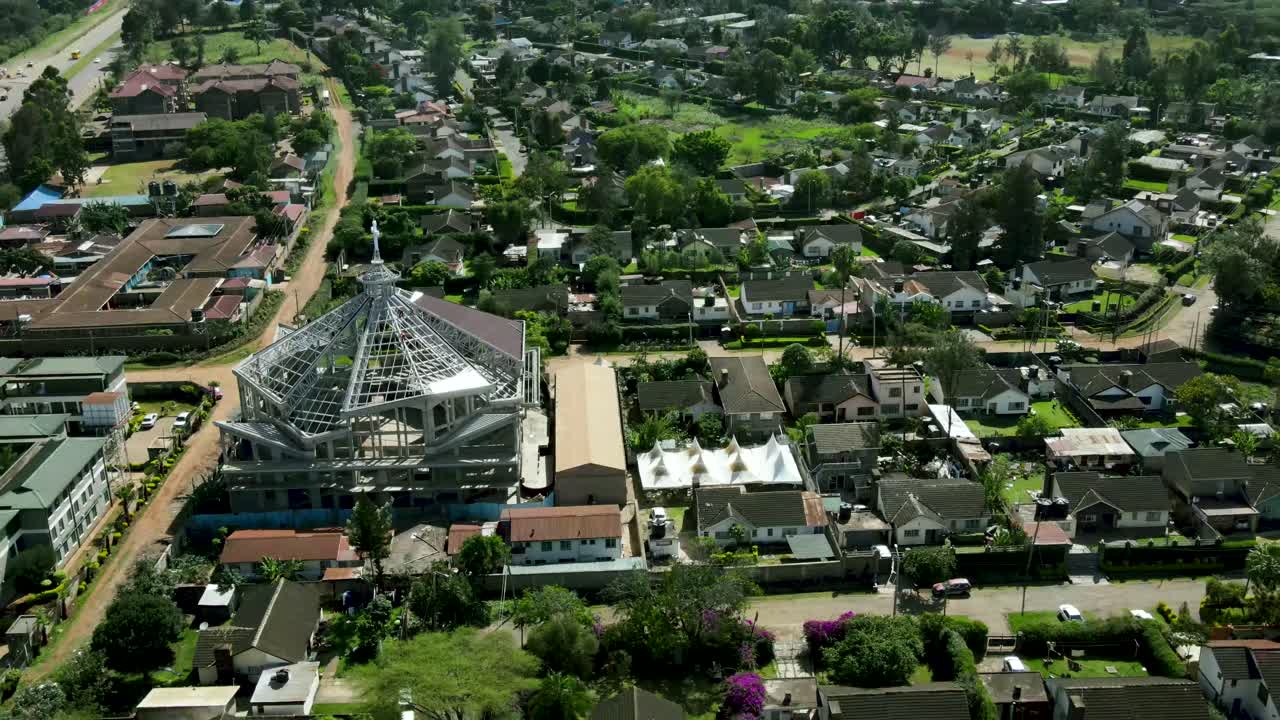 Aerial top down over suburb district of Nairobi with church during sunny day